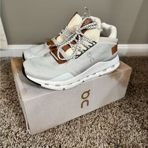 On Running Cream and Brown Athletic Shoes